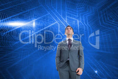 Composite image of unsmiling businessman standing