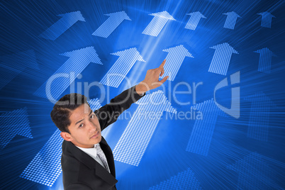 Composite image of unsmiling asian businessman pointing Composite image of unsmiling asian businessman pointing