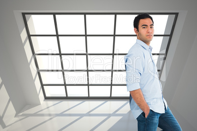 Composite image of unsmiling casual man standing