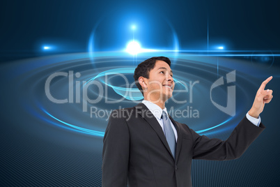 Composite image of smiling asian businessman pointing