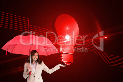 Composite image of happy businesswoman holding umbrella