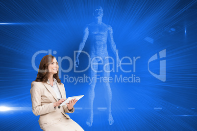 Composite image of businesswoman holding tablet and looking up