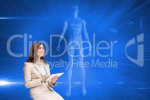 Composite image of businesswoman holding tablet and looking up