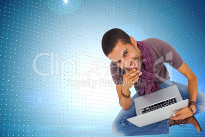 Composite image of thoughtful man sitting on floor using laptop