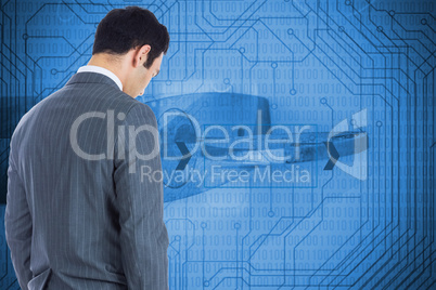 Composite image of unsmiling businessman standing