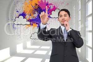 Composite image of thoughtful asian businessman pointing