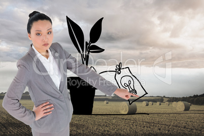 Composite image of unsmiling asian businesswoman pointing