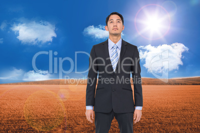 Composite image of serious asian businessman