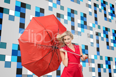 Composite image of smiling blonde holding umbrella