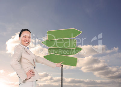 Composite image of smiling asian businesswoman pointing