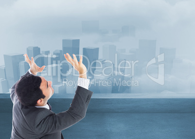 Composite image of unsmiling businessman with arms raised