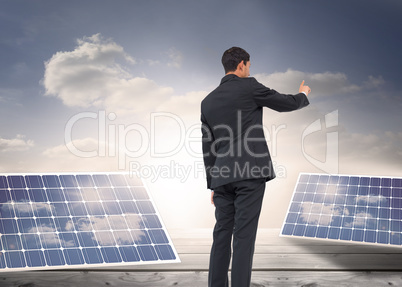 Composite image of asian businessman pointing