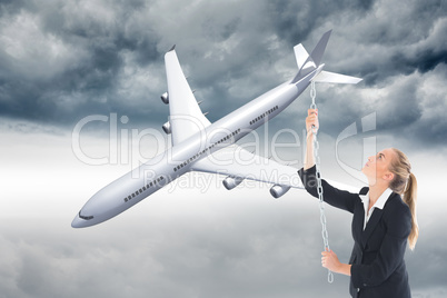 Composite image of businesswoman pulling a chain