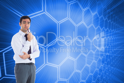 Composite image of thinking businessman holding glasses