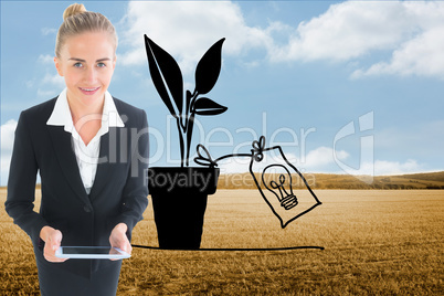 Composite image of businesswoman holding new tablet