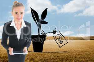 Composite image of businesswoman holding new tablet