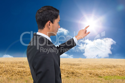 Composite image of stern asian businessman pointing