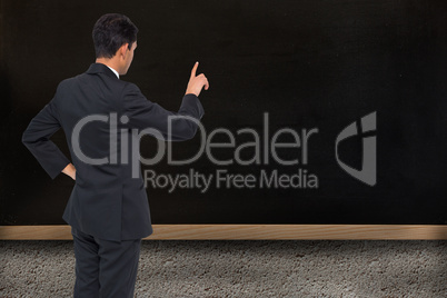 Composite image of asian businessman pointing