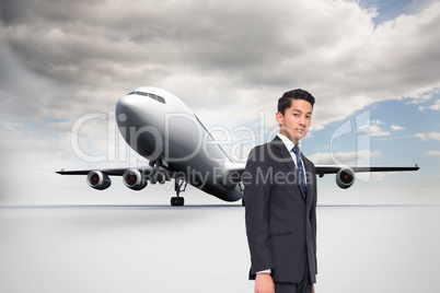 Composite image of frowning businessman looking at camera