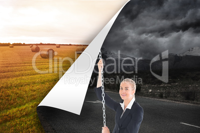 Composite image of businesswoman pulling a chain