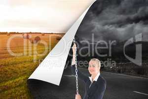 Composite image of businesswoman pulling a chain