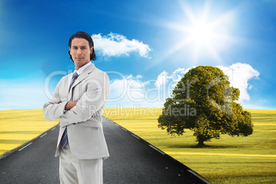 Composite image of serious office worker posing with the arms cr