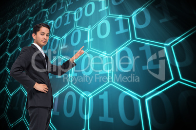 Composite image of unsmiling asian businessman pointing Composite image of unsmiling asian businessman pointing