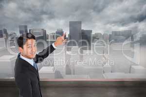 Composite image of smiling asian businessman pointing