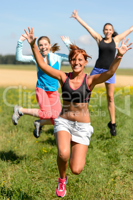 cheerful friends jumping enjoy summer sport run