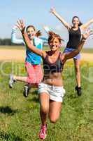 cheerful friends jumping enjoy summer sport run
