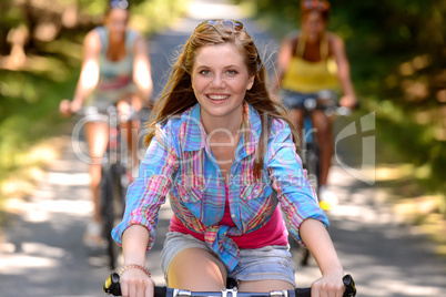 teenage girl riding bike with friends