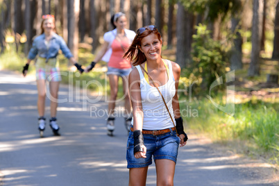 young woman roller skating outdoors with friends