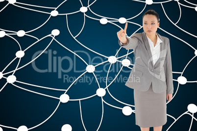 Composite image of unsmiling asian businesswoman pointing