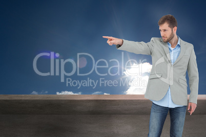 Composite image of trendy model pointing to something