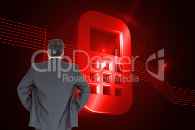 Composite image of businessman standing back to the camera with