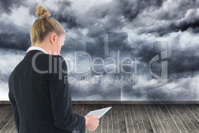 Composite image of businesswoman holding tablet