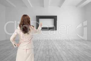 Composite image of businesswoman standing back to camera writing