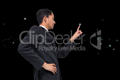 Composite image of unsmiling asian businessman pointing