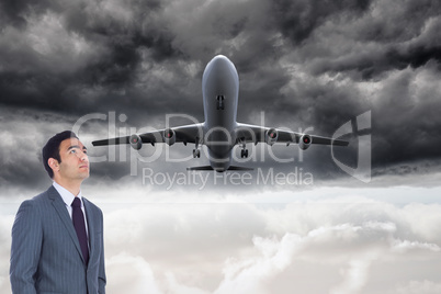 Composite image of unsmiling businessman standing