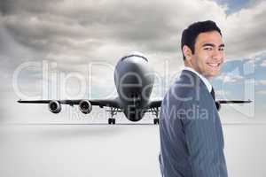 Composite image of smiling businessman standing