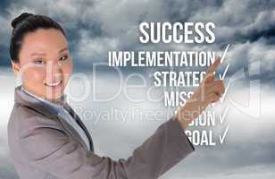 Composite image of smiling asian businesswoman pointing