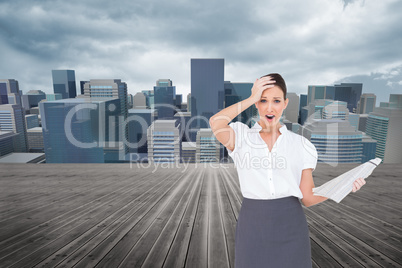 Composite image of shocked classy businesswoman holding newspape