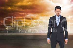 Composite image of serious asian businessman