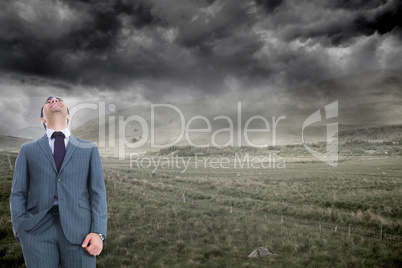 Composite image of businessman standing