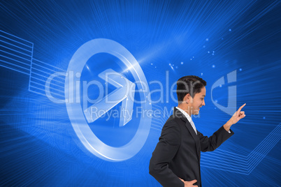 Composite image of smiling asian businessman pointing