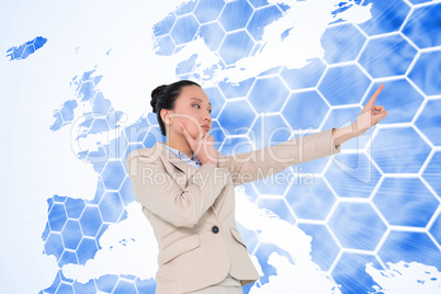 Composite image of thoughtful asian businesswoman pointing