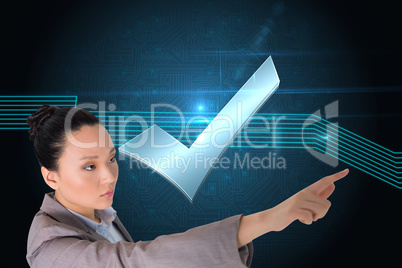 Composite image of unsmiling asian businesswoman pointing