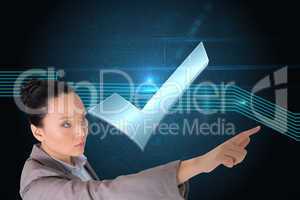 Composite image of unsmiling asian businesswoman pointing