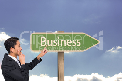 Composite image of thoughtful asian businessman pointing