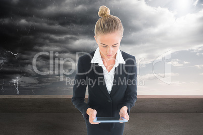 Composite image of businesswoman holding new tablet